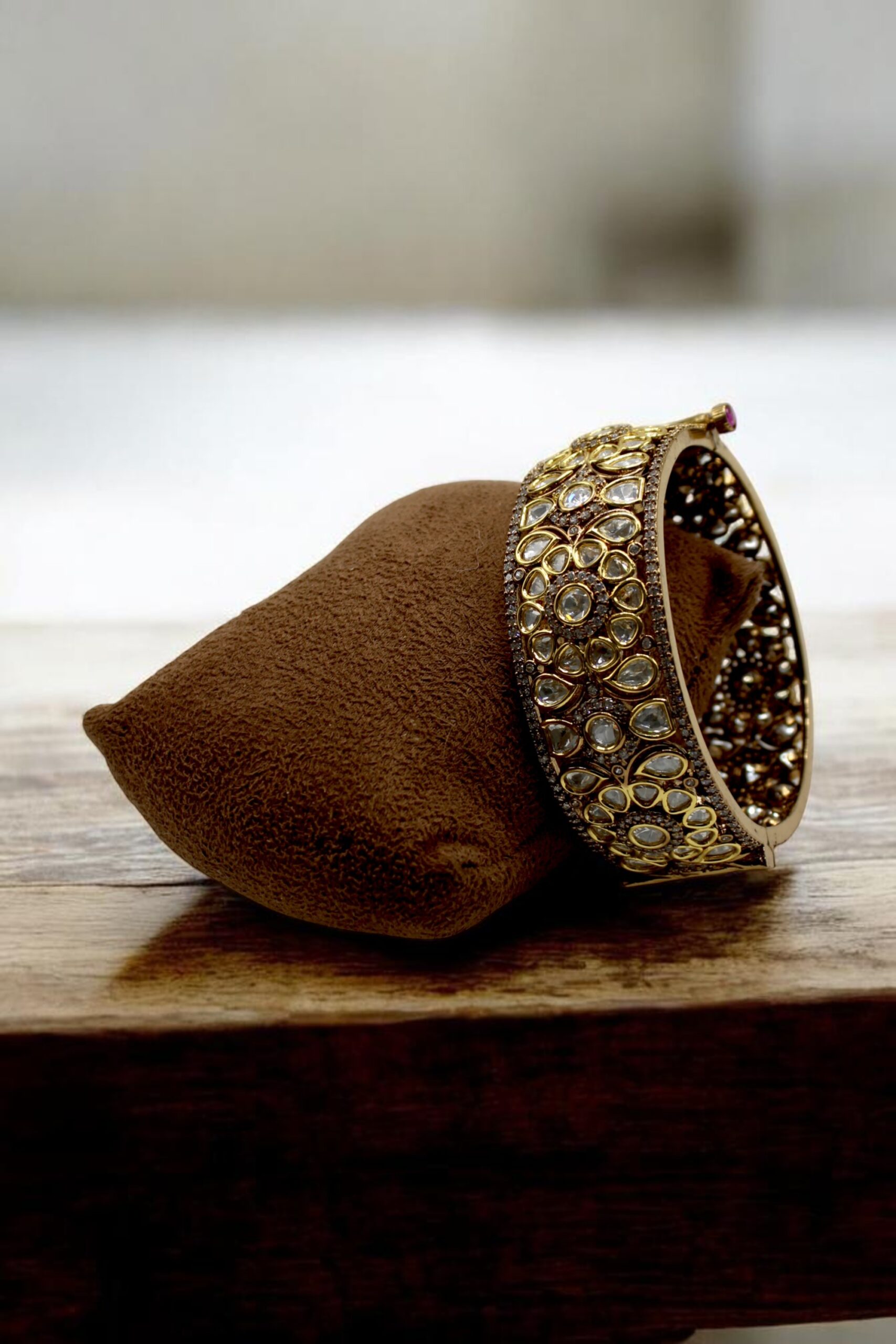 Elegant Antique Gold and Gemstone Bangle on Velvet Display - Image 3