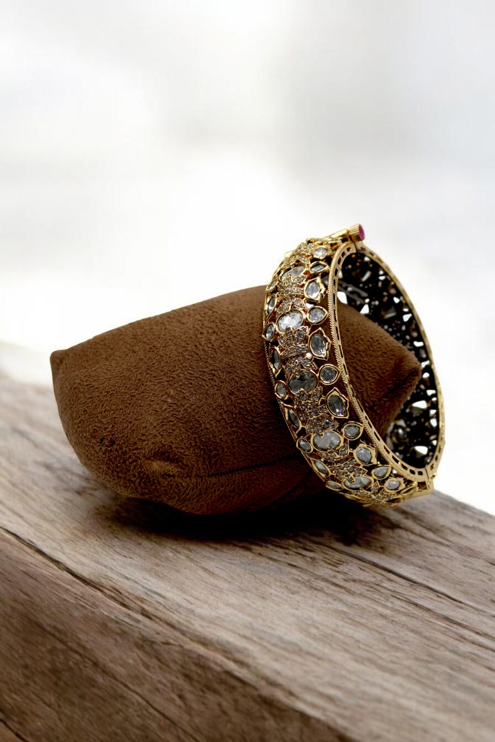 Elegant Gold and Diamond-Studded Bangle on Velvet Display - Image 3