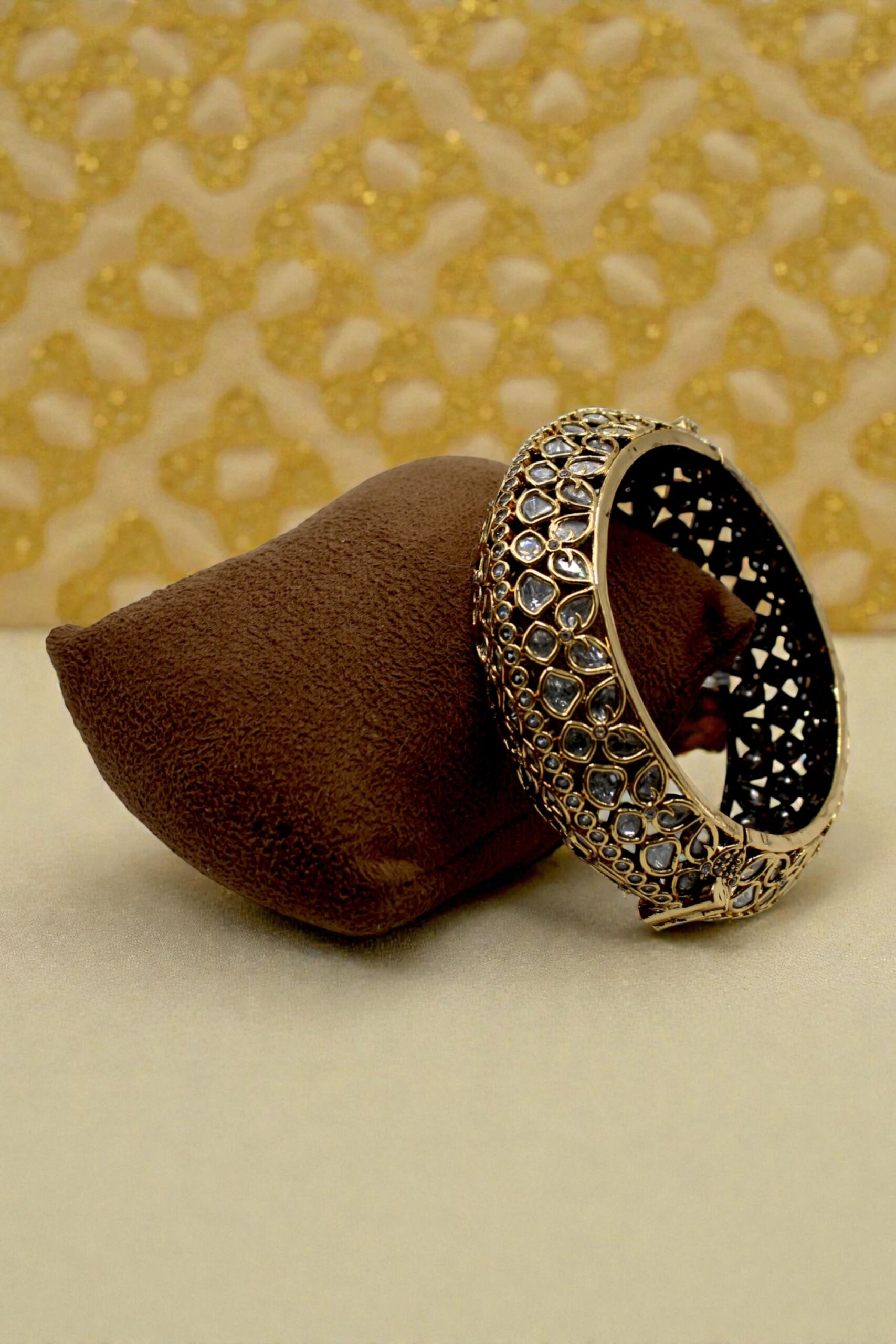 Elegant Gold and Stone-Studded Bangle on Velvet Pouch - Image 2