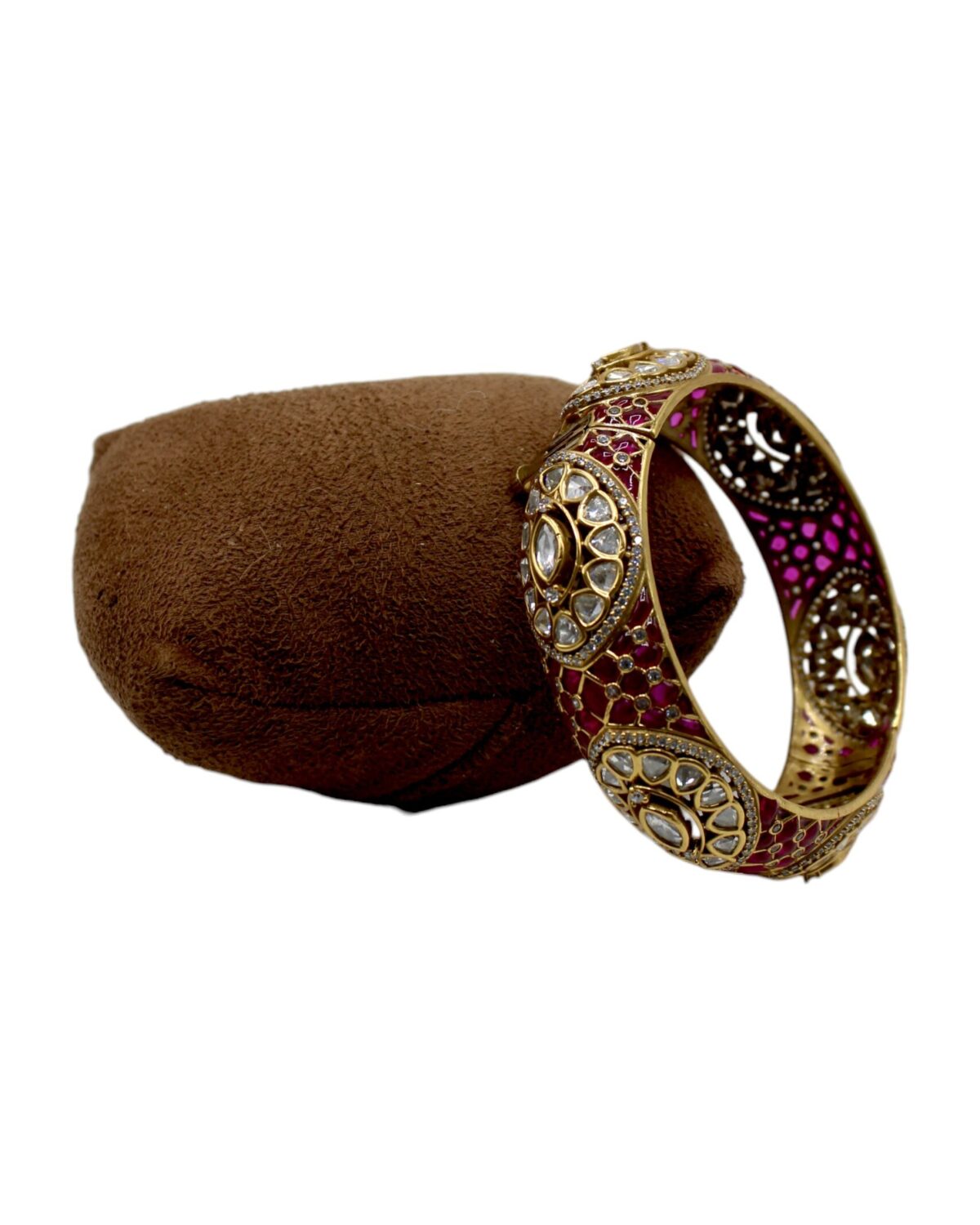 Elegant Gold and Ruby Bangle on Velvet Cushion