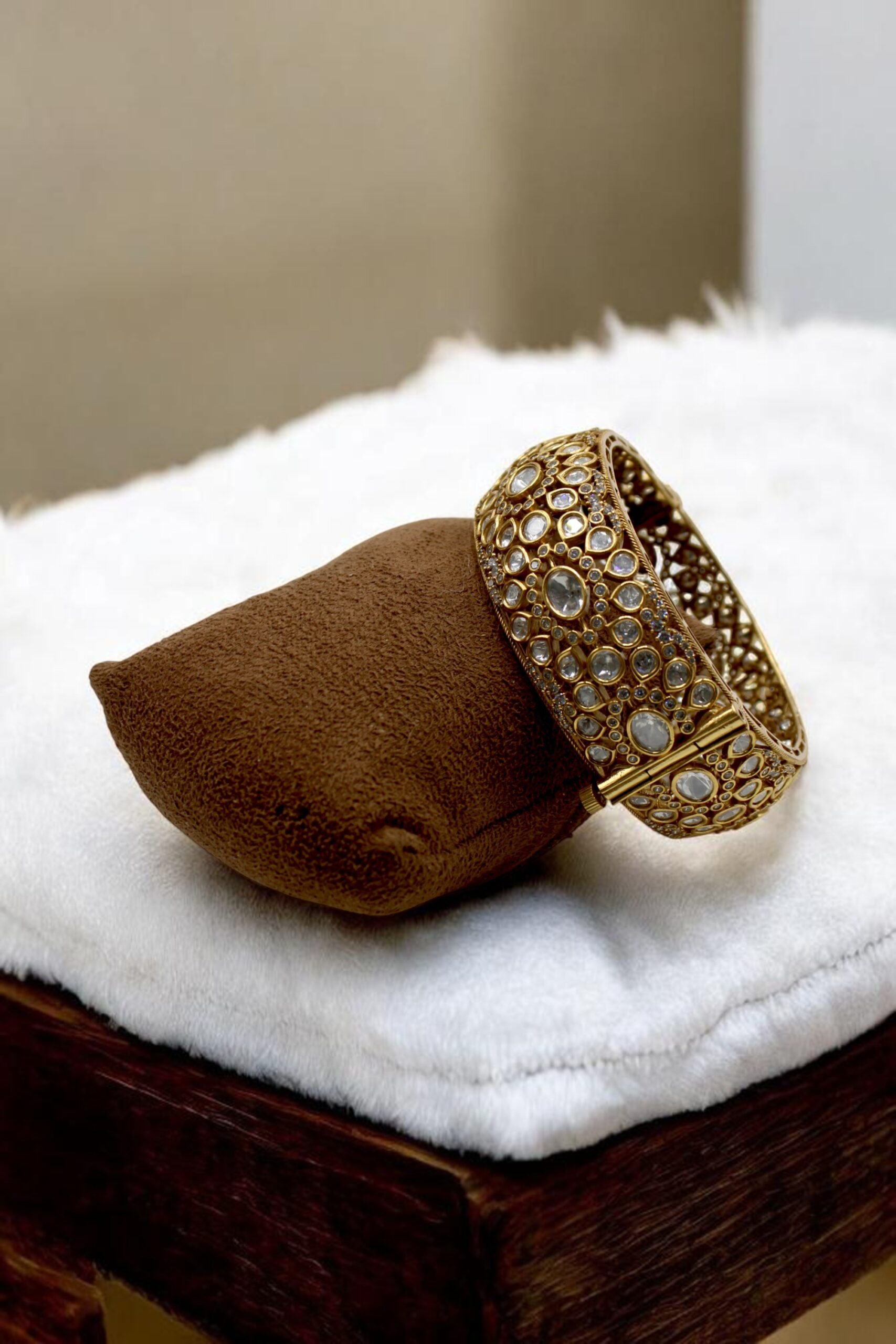 Elegant Gold and Stone-Studded Bracelet on Velvet Display - Image 3