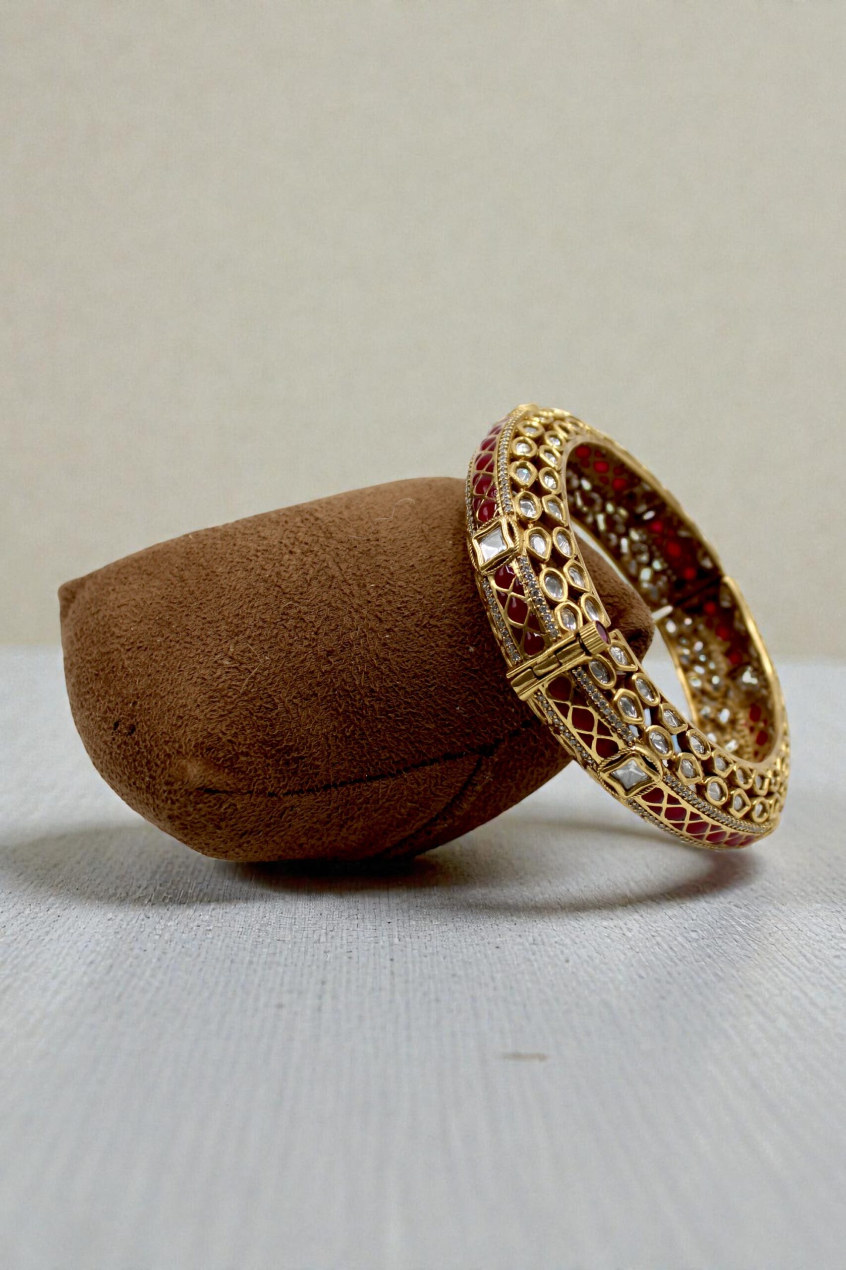 Elegant Gold and Red Stone Bangle on Velvet Display - Image 2