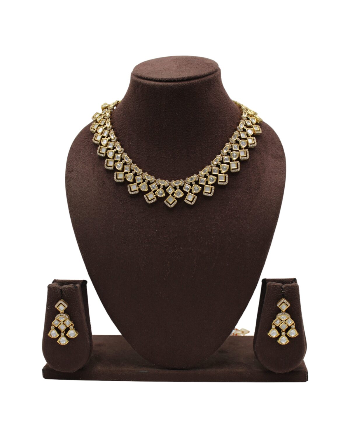 Elegant Gold Necklace and Earring Set Displayed on a Bust Stand