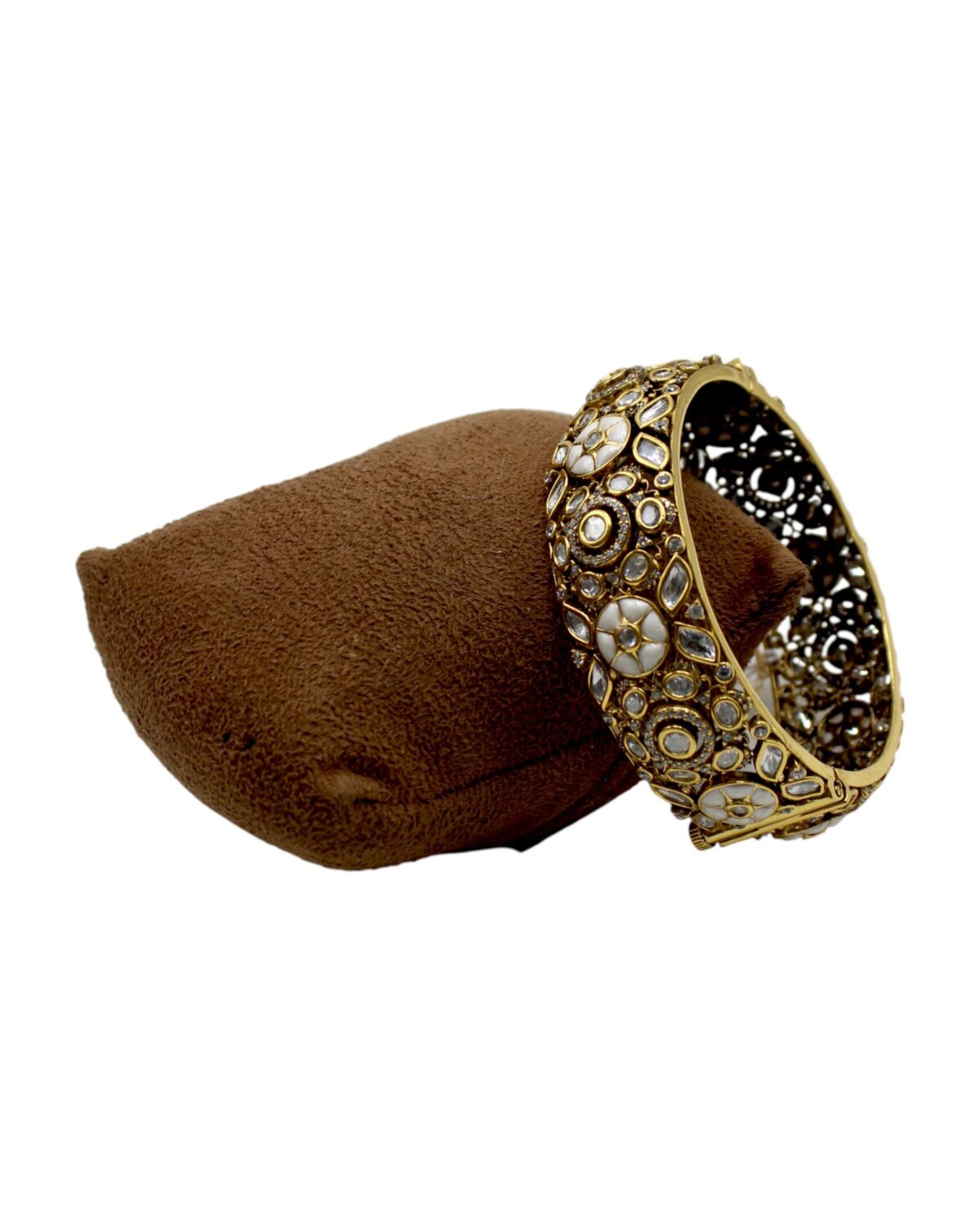 Elegant Gold and Stone-Studded Bangle on Velvet Cushion