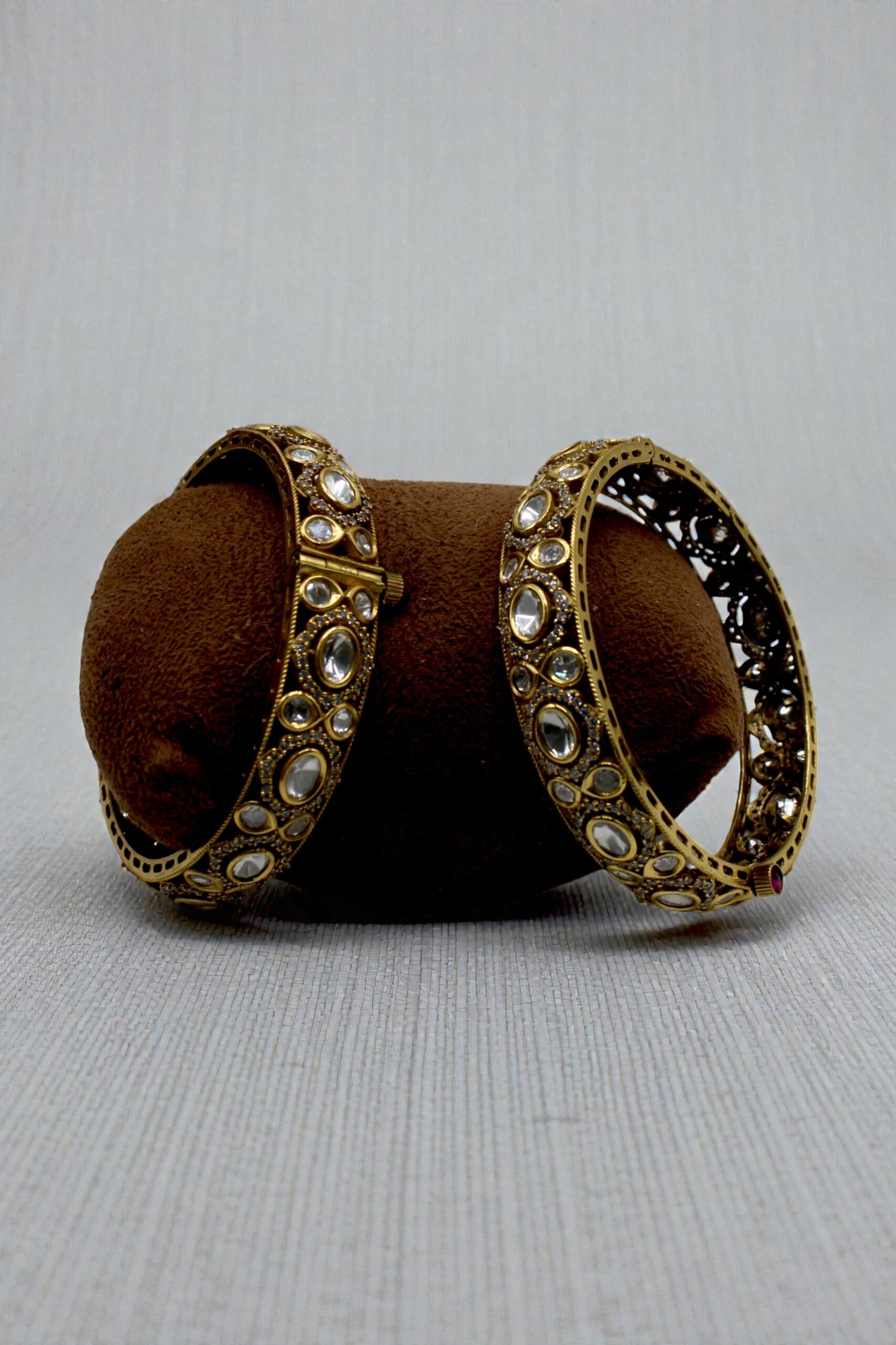 Elegant Gold Bangles with Intricate Design and Gemstone Accents - Image 2